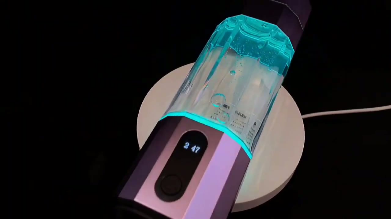 QY01 touch-screen base seen from above beside the bottle